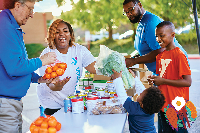 YMCA volunteer giving donated food to a community member.